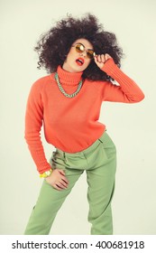 Young Woman Wearing A 70s Retro Clothes Striking A Pose In Studio. Disco Diva