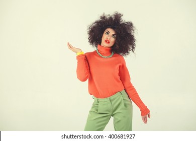 Young Woman Wearing A 70s Retro Clothes Striking A Pose In Studio. Disco Diva