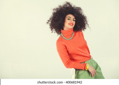 Young Woman Wearing A 70s Retro Clothes Striking A Pose In Studio. Disco Diva