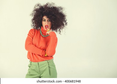 Young Woman Wearing A 70s Retro Clothes Striking A Pose In Studio. Disco Diva