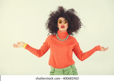 Young Woman Wearing A 70s Retro Clothes Striking A Pose In Studio. Disco Diva