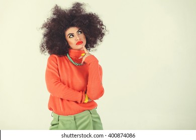 Young Woman Wearing A 70s Retro Clothes Striking A Pose In Studio. Disco Diva