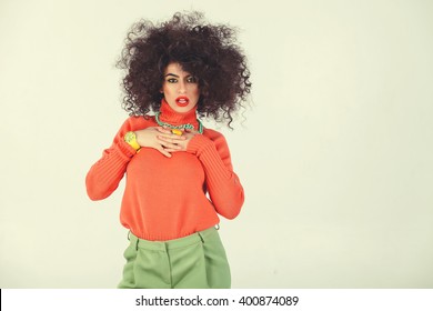 Young Woman Wearing A 70s Retro Clothes Striking A Pose In Studio. Disco Diva