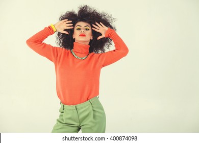 Young Woman Wearing A 70s Retro Clothes Striking A Pose In Studio. Disco Diva