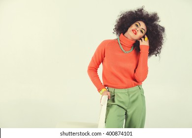 Young Woman Wearing A 70s Retro Clothes Striking A Pose In Studio. Disco Diva