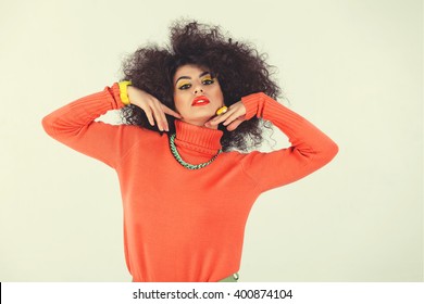 Young Woman Wearing A 70s Retro Clothes Striking A Pose In Studio. Disco Diva