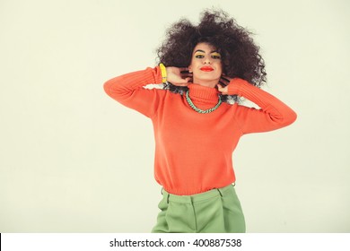 Young Woman Wearing A 70s Retro Clothes Striking A Pose In Studio. Disco Diva