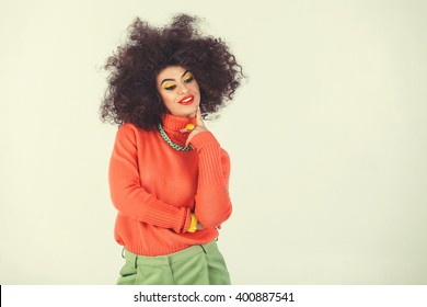 Young Woman Wearing A 70s Retro Clothes Striking A Pose In Studio. Disco Diva