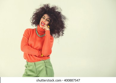 Young Woman Wearing A 70s Retro Clothes Striking A Pose In Studio. Disco Diva