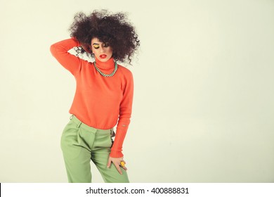 Young Woman Wearing A 70s Retro Clothes Striking A Pose In Studio. Disco Diva