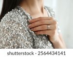 Young woman wearing beautiful engagement ring, closeup