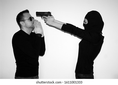 Young Woman Wearing Black Helmet And Putting Gun To Head Of Man