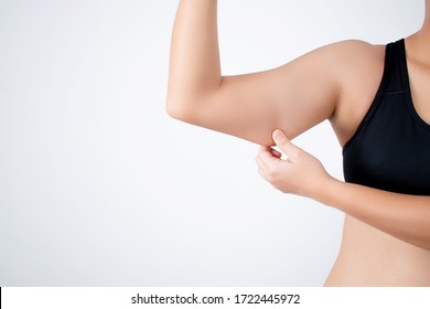 Young woman wearing a black workout outfit is pulling under her arm because she has fat under her arm.