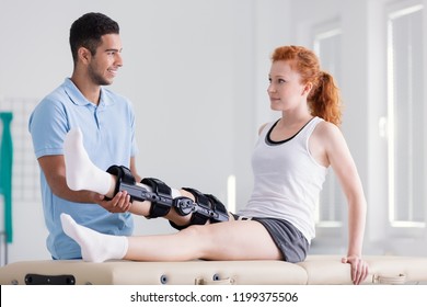 Young woman wearing a brace during rehabilitation with her physiotherapist - Powered by Shutterstock