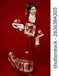 Young woman wearing Chinese Hanfu against a festive red background