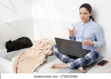 Young woman wearing cozy clothes in video call from bed – Freelance girl in virtual conference smart working remotely early in morning from home due to pandemic isolation quarantine.