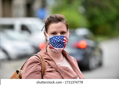 Young Woman Wearing A DIY Facemask Designed As The Flag Of USA For Protection Against Coronavirus.