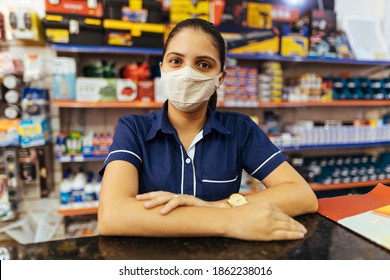 Young woman wearing face mask working in hardware store - Shutterstock ID 1862238016