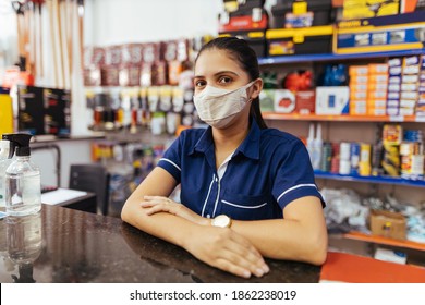 Young woman wearing face mask working in hardware store - Shutterstock ID 1862238019