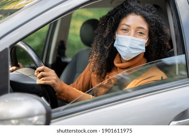 Young Woman Wearing Face Mask And Driving Car