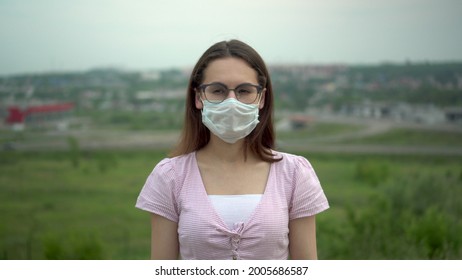 Young woman wearing glasses wearing a medical mask. - Powered by Shutterstock