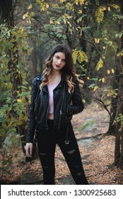 Young Woman Wearing Leather Jacket In Nature