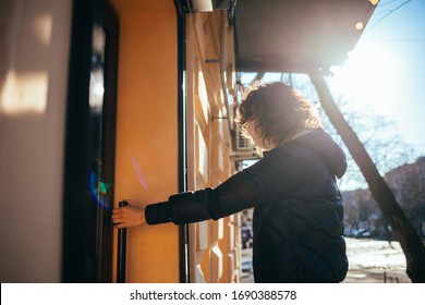 Young Woman Wearing Medical Face Mask Open Cafe Door Holding Handle With Bare Hand.