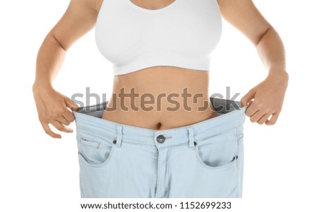 Young woman wearing oversize pants on white background. Healthy diet