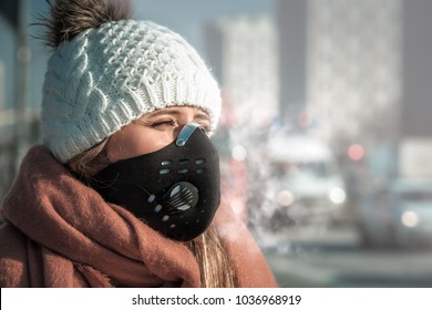 Young woman wearing protective mask in the city street, smog and air pollution during winter - Powered by Shutterstock