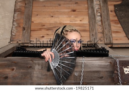 Young woman wearing punk clothing and makeup in deserted location