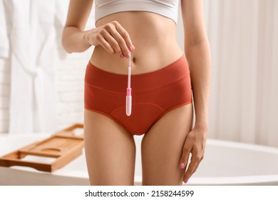 Young Woman Wearing Red Period Panties With Tampon In Bathroom