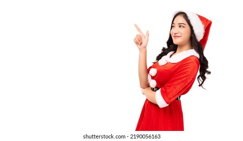 Young woman wearing red Santa Claus outfit and Santa Claus Hat pointing up to copy space isolated on white background Christmas x-mas winter happiness holiday and party concept  - Powered by Shutterstock