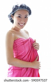 Young Woman Wearing Shower Cap And Towel, Smiling At Camera