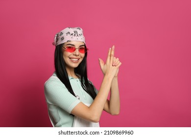 Young woman wearing stylish bandana and sunglasses on pink background, space for text - Shutterstock ID 2109869960