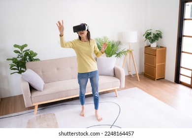 Young woman wearing virtual reality goggles at bedroom, VR innovation technology - Shutterstock ID 2248164457