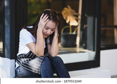 Young Woman Wearing Waitress Apron Feeling Suffering From Desperate And Stressed. 