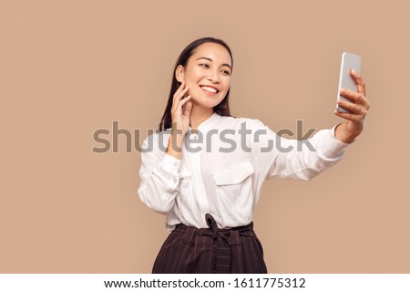 Similar – Image, Stock Photo Woman takes a picture on her mobile phone of domestic black and white cows grazing in a field in the Flanders region, Belgium
