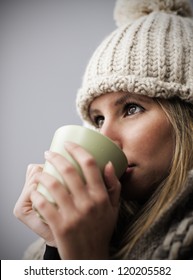 Young Woman Wearing Winter Clothes Having A Hot Drink