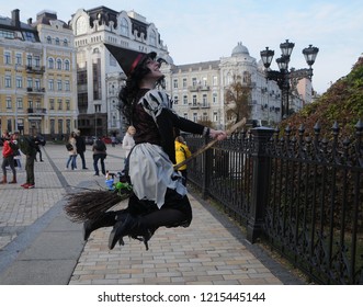 A young woman wearing a witch costume jumps like she flying on a broomstick, in front the St. Sophia Cathedral during Halloween Zombie Walk 2018 parade, in Kiev, Ukraine, 27 October 2018.