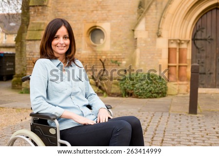 young woman in a wheelchair outside a church