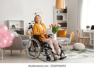 Young woman in wheelchair reading book at home. International Women's Day - Powered by Shutterstock