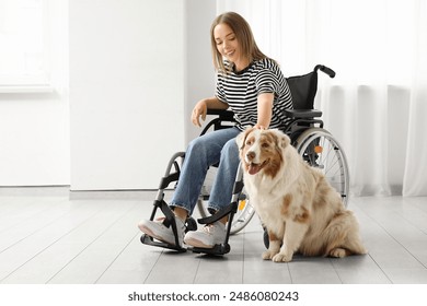 Young woman in wheelchair with service dog indoors - Powered by Shutterstock