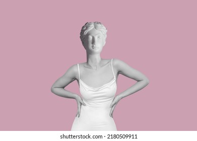 Young woman in white elegant dress headed by antique female statue isolated on a pink background. Trendy collage in magazine surreal style. Contemporary art. Modern design