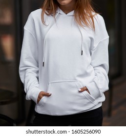  young woman in white hoodie hands in the pockets close up mockup copyspace