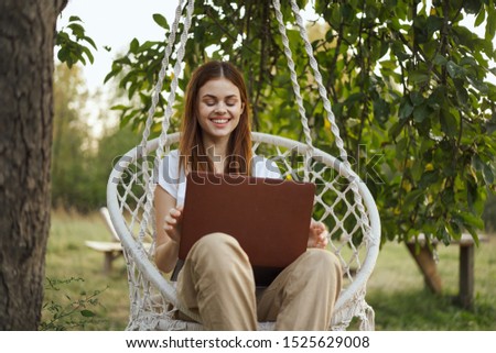young woman in a white laptop on the nature