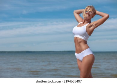 Young Woman In White Lingerie By The Sea