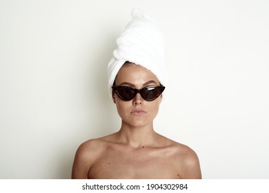 Young Woman With A White Towel Turban On Her Head And In Sunglasses. A Wonderful Pretentious Model