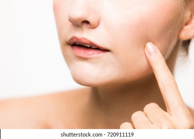 young woman who checks her skin. acne treatment.