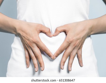 Young Woman Who Makes A Heart Shape By Hands On Her Stomach.