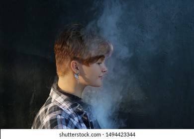 Young Woman Who Are Secretly Smoking At School. Smoking Girl.Vape Party. Sexy Young Woman With Glamorous Mystical Makeup Vaping In Nightclub (exhaling Smoke)